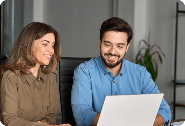 Two professionals working together on a laptop