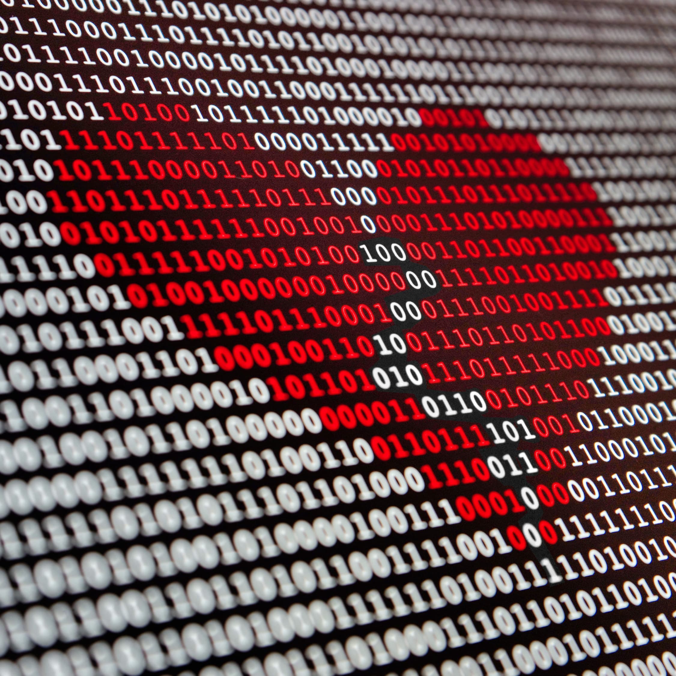 White zeros and ones on a black background to signify data. Some of the zeros and ones are red, forming a broken heart.